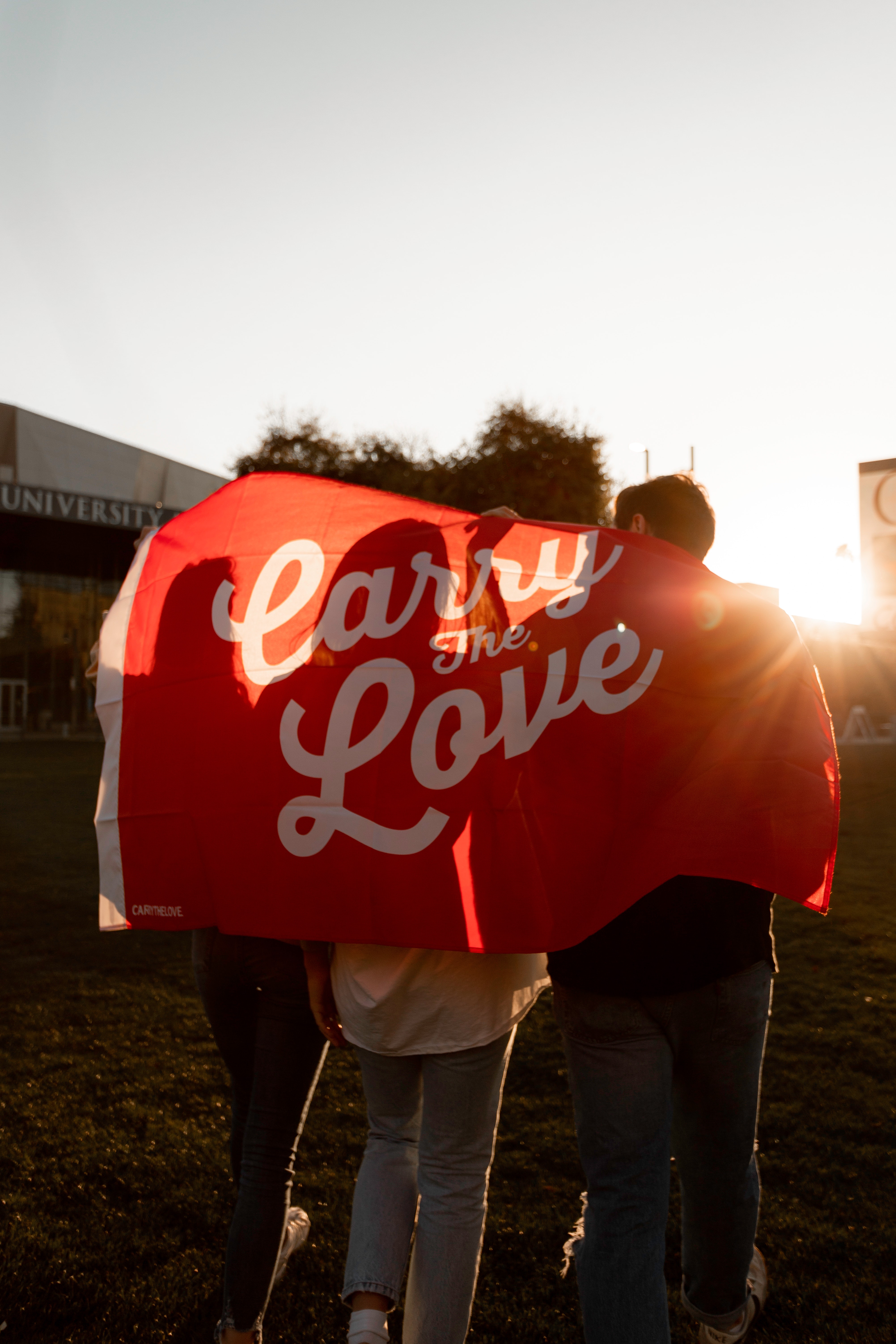 people-holding-red-and-white-love-banner-3701040