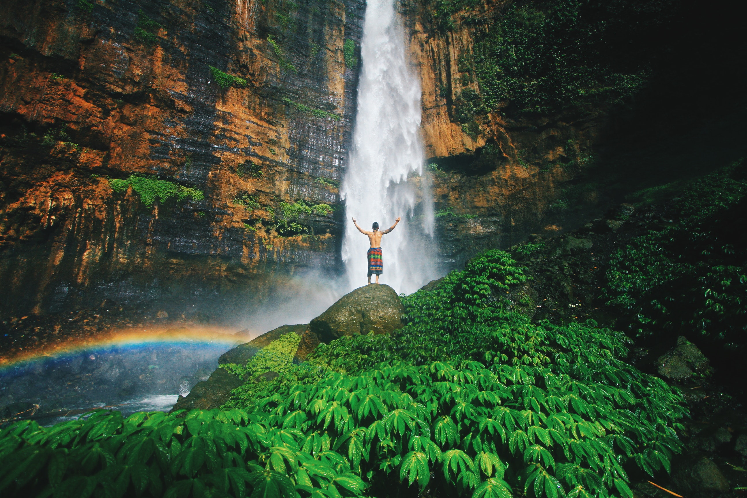 photo-of-man-standing-on-top-of-rock-3283186