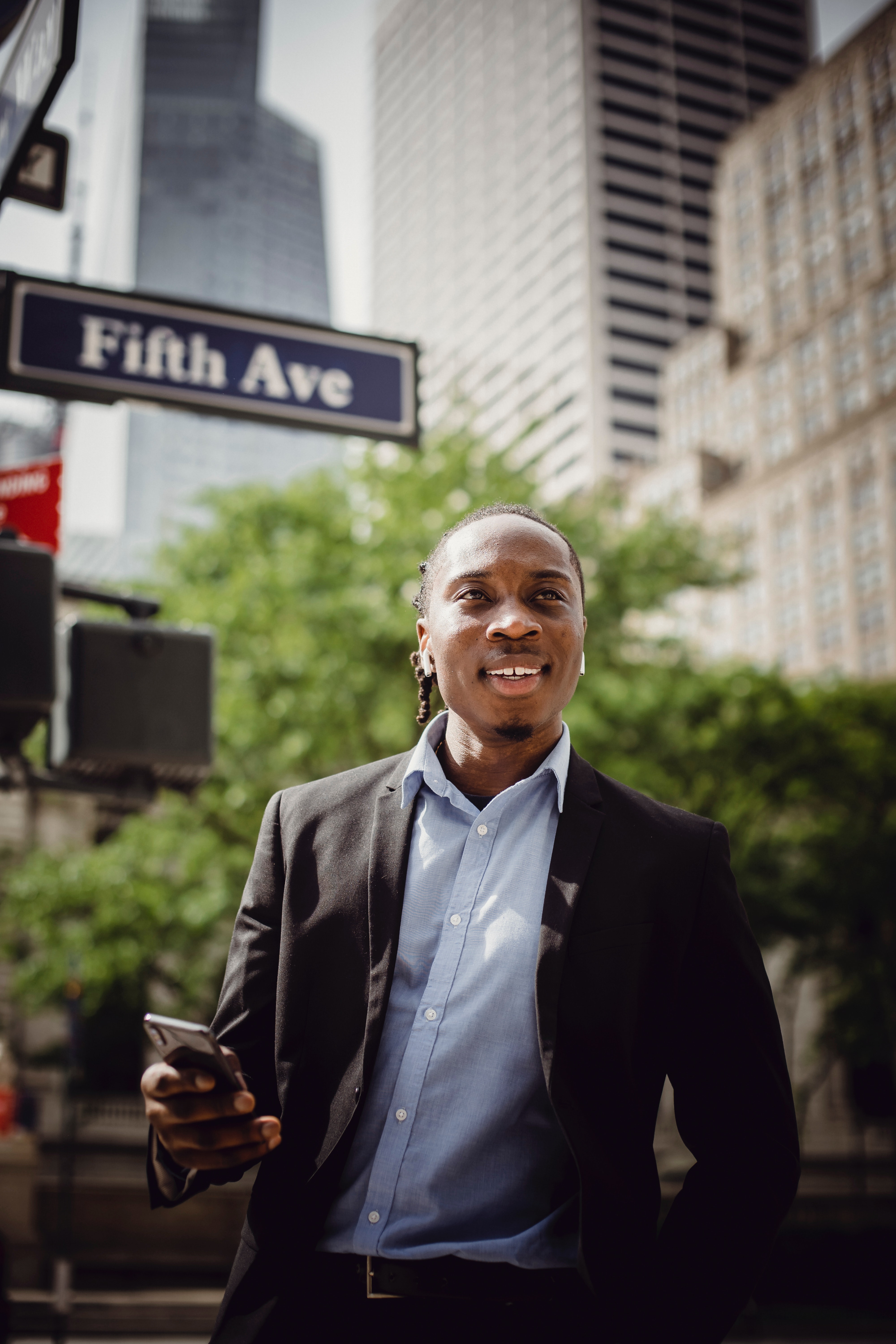 positive-businessman-listening-to-music-on-new-york-street-4559741